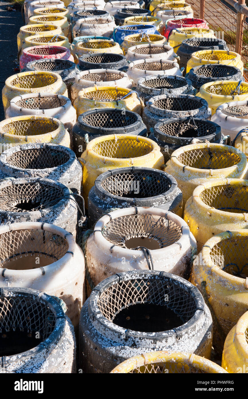 stacks of buckie pots - for catching whelks - on the quayside at Drummore Harbour, Rhins of Galloway, Dumfries and Galloway, SW Scotland Stock Photo