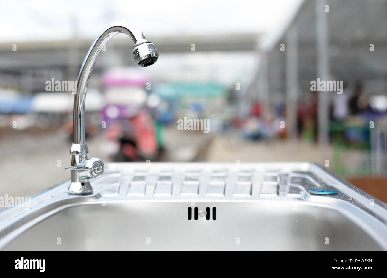 Water tap on stainless steel kitchen sink Stock Photo - Alamy