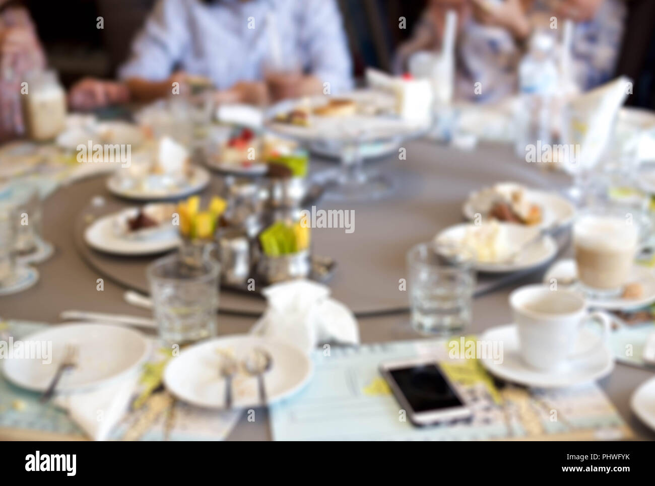 Blurry group of people after having food and cake leftover Stock 