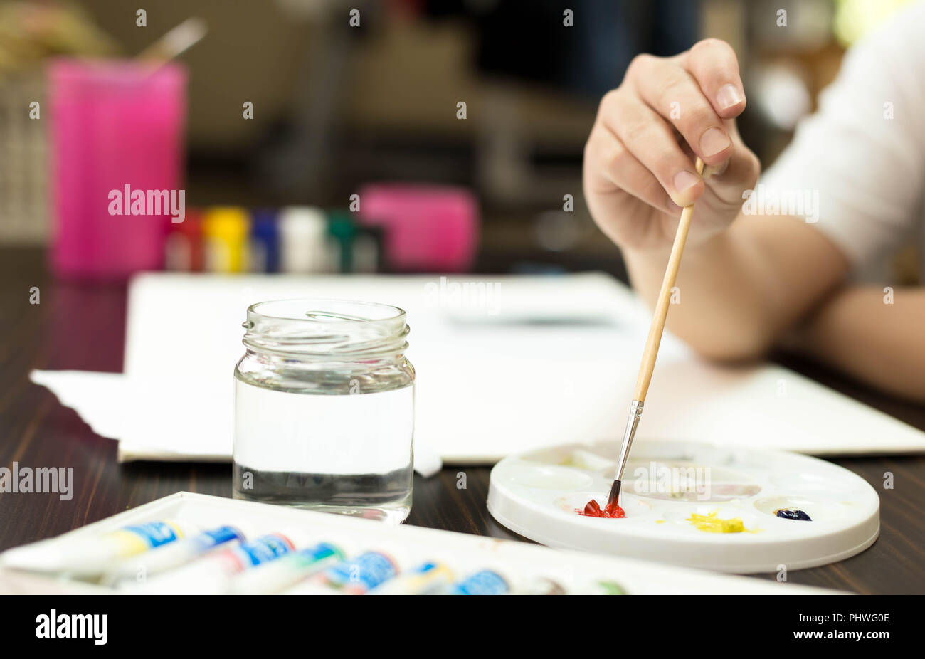 The artist mixes paint of different colors on palette Stock Photo