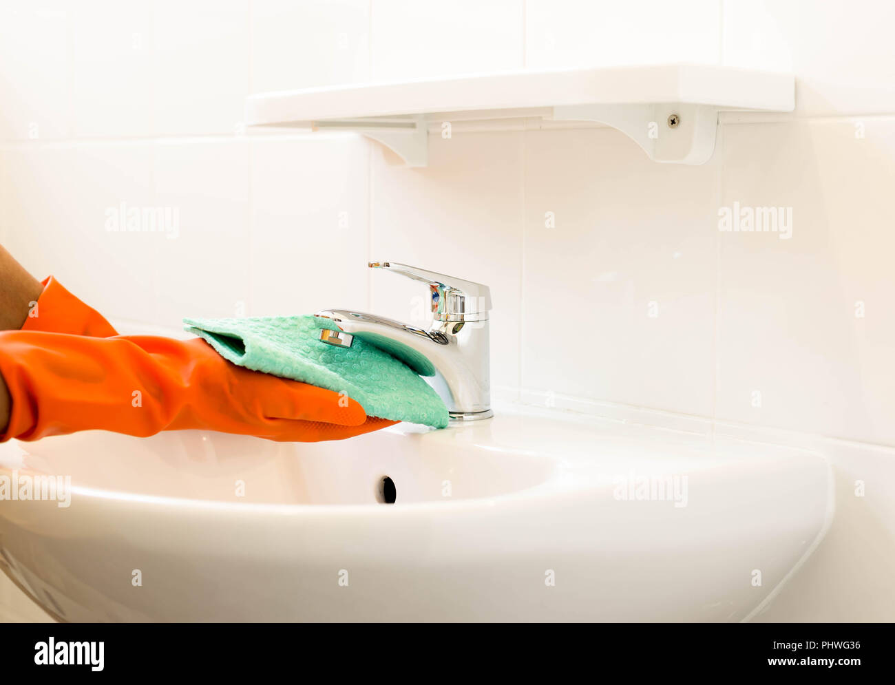 Woman cleaning water tap Stock Photo Alamy