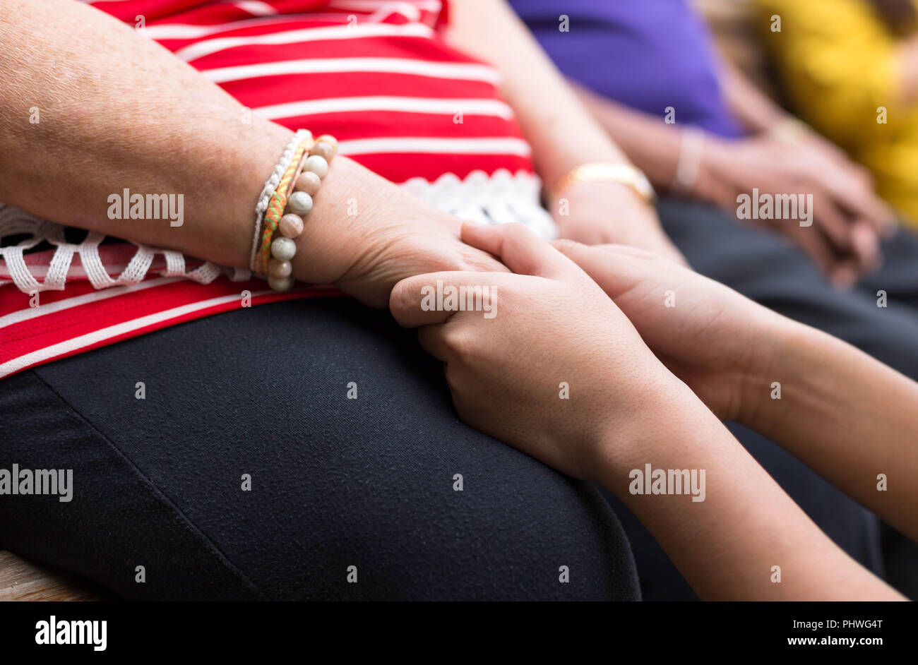Old woman and child holding hand Stock Photo