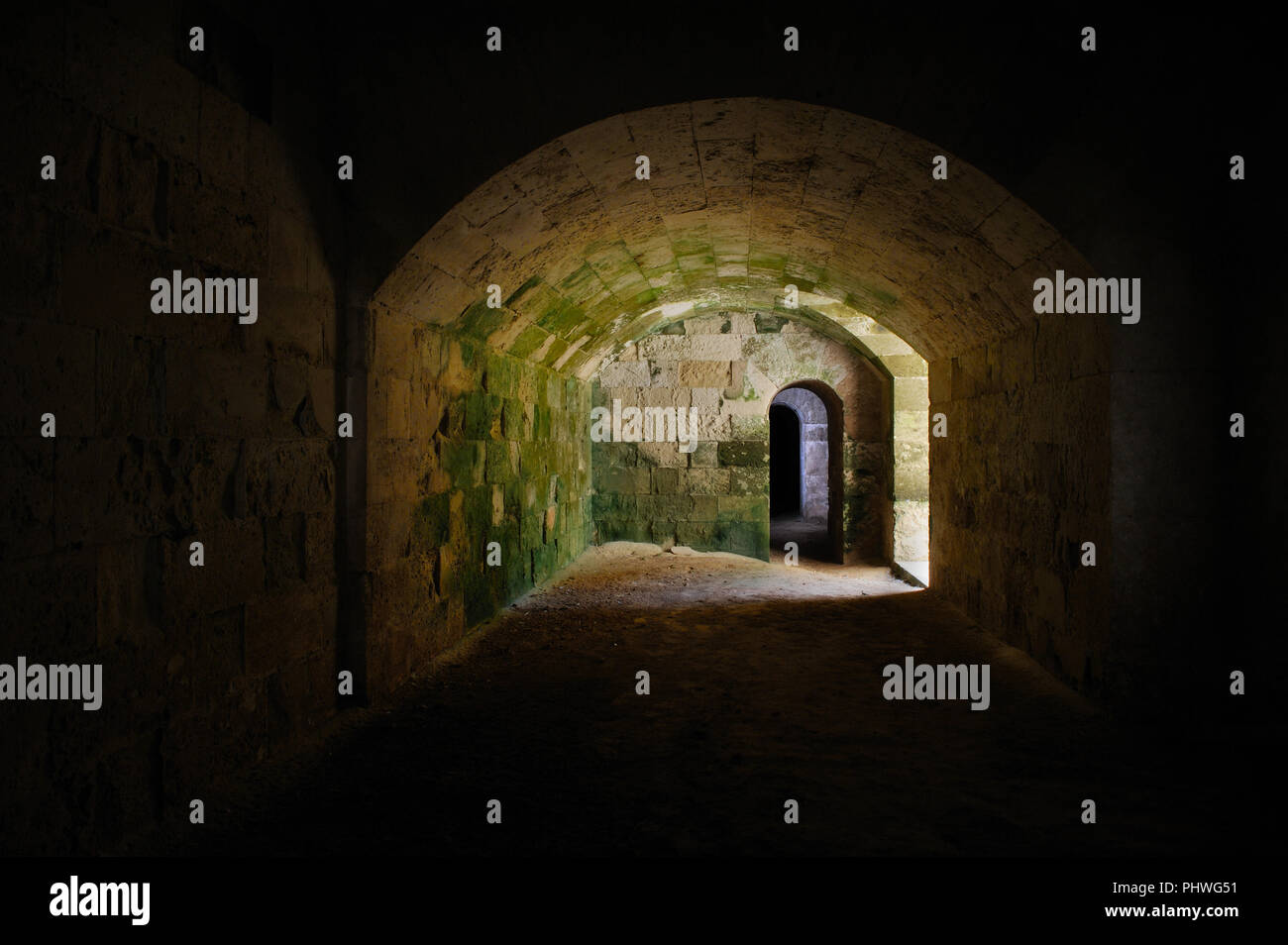 Dark, deep tunnels and cellars beneath the fortifications of La Mola fortress in Menorca, Spain Stock Photo