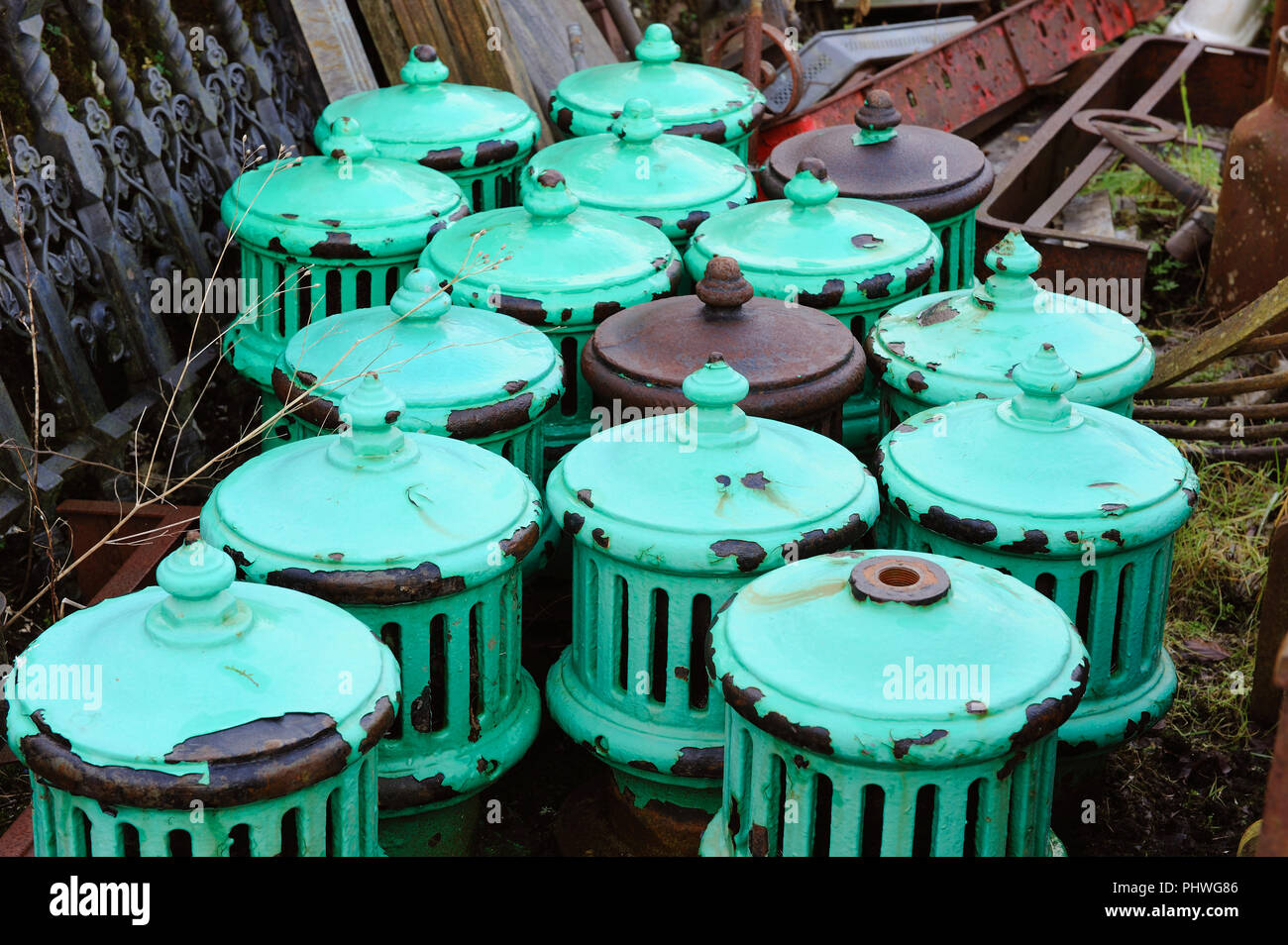 Old cast iron ventilators stacked in a scrapyard Stock Photo