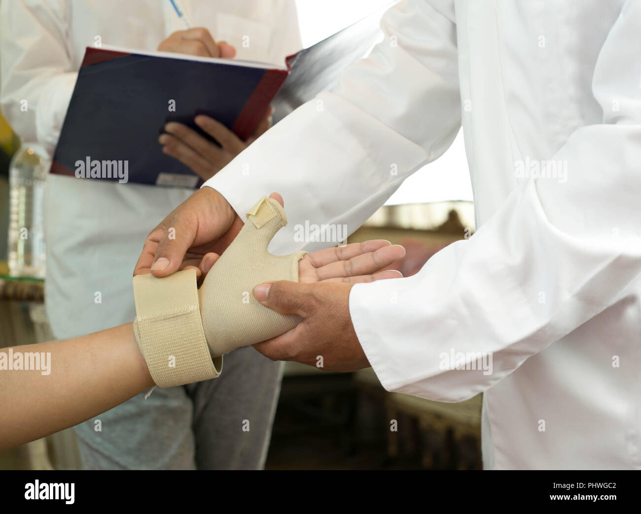 Doctor bandaging  patient is hand injuries  Stock Photo