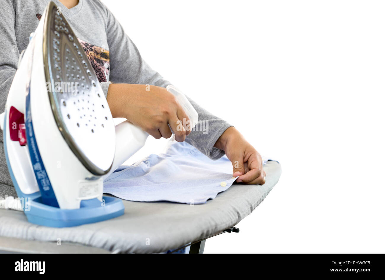 housekeeper ironing clothes on ironing board in isolated Stock Photo