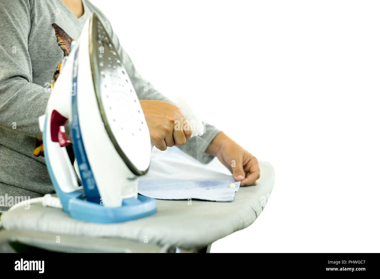housekeeper ironing clothes on ironing board in isolated Stock Photo