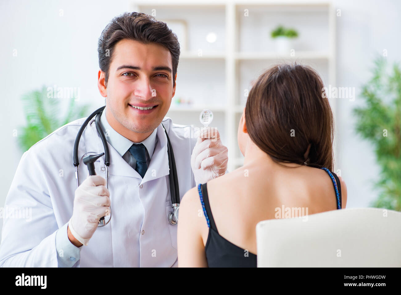Doctor checking patients ear during medical examination Stock Photo Alamy