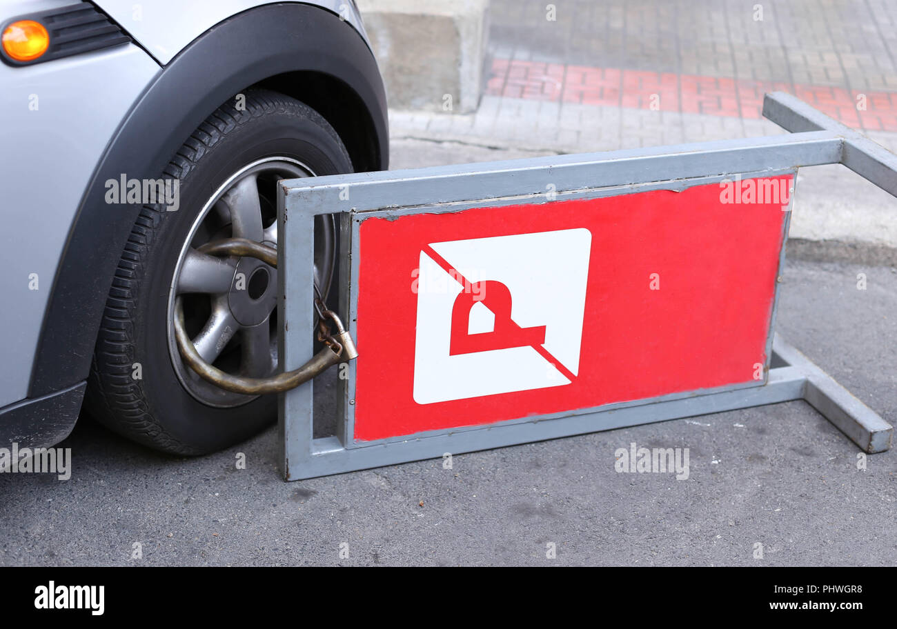 clamped front wheel of illegally parked car Stock Photo