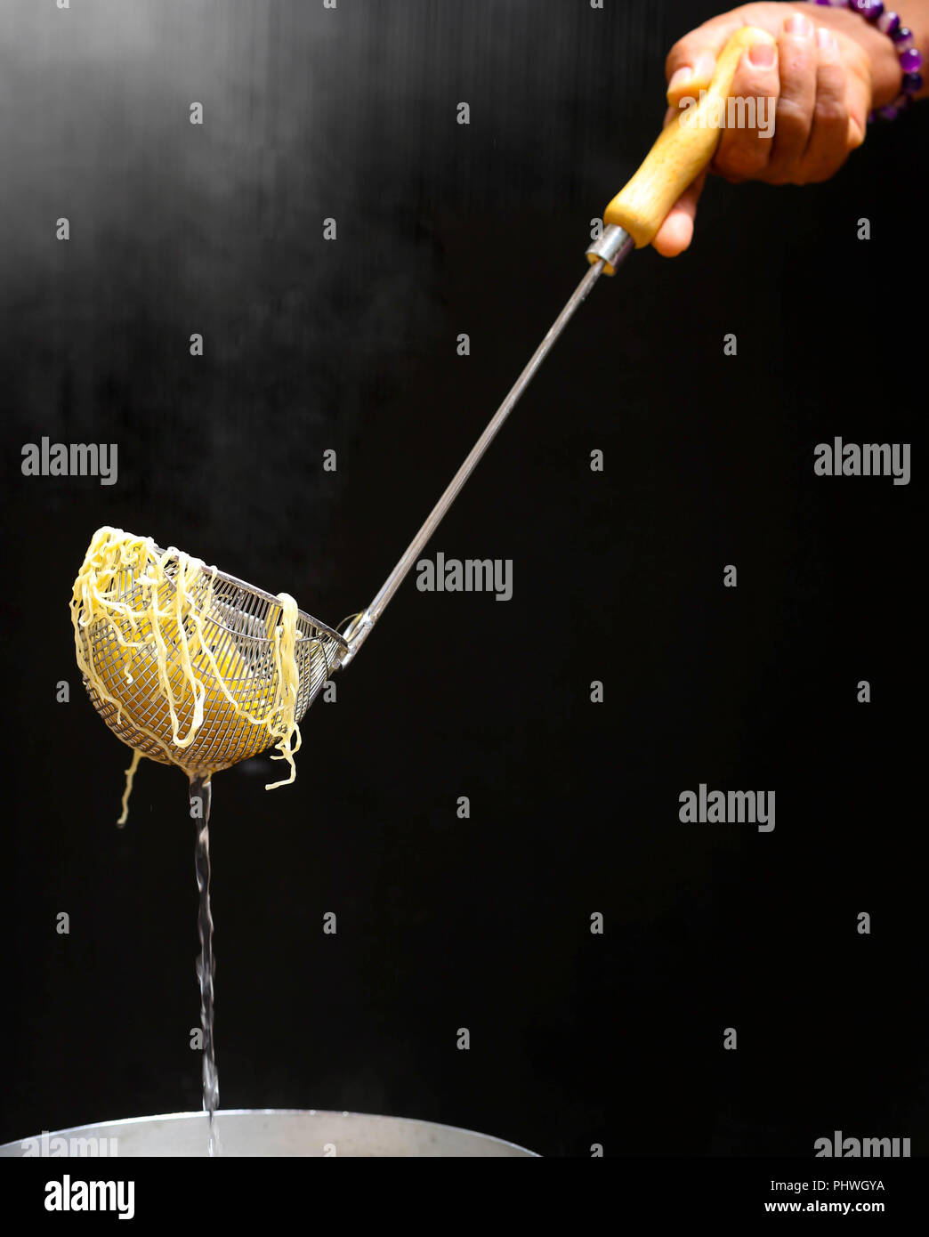 Cooking egg or yellow noodle in hot water Stock Photo Alamy