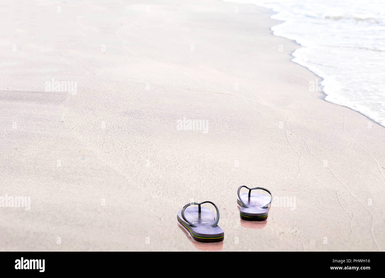 Sandals flip flops on the beach Stock Photo - Alamy