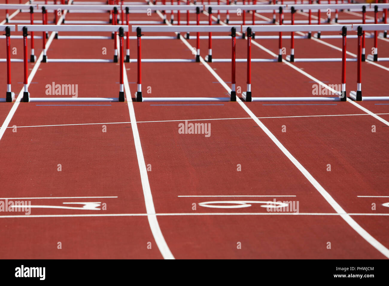 Hurdles on competition background Stock Photo Alamy