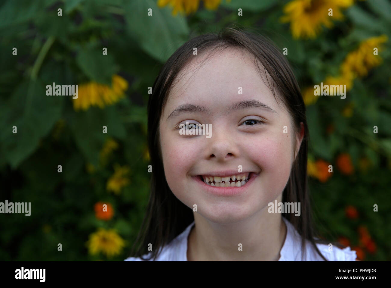 Portrait of little girl smiling in the garden Stock Photo - Alamy