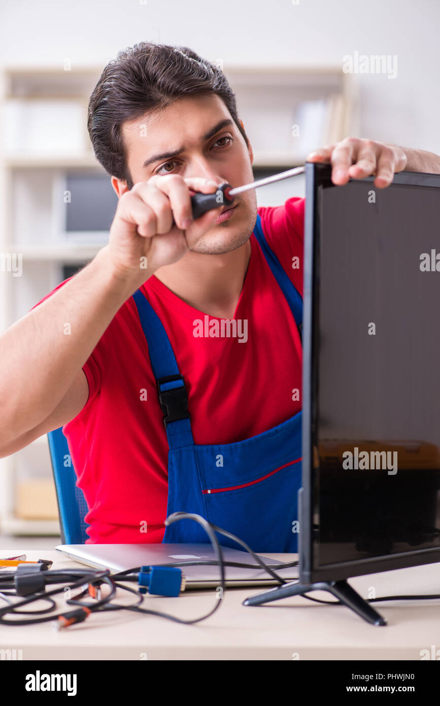 Professional repair engineer repairing broken tv Stock Photo Alamy
