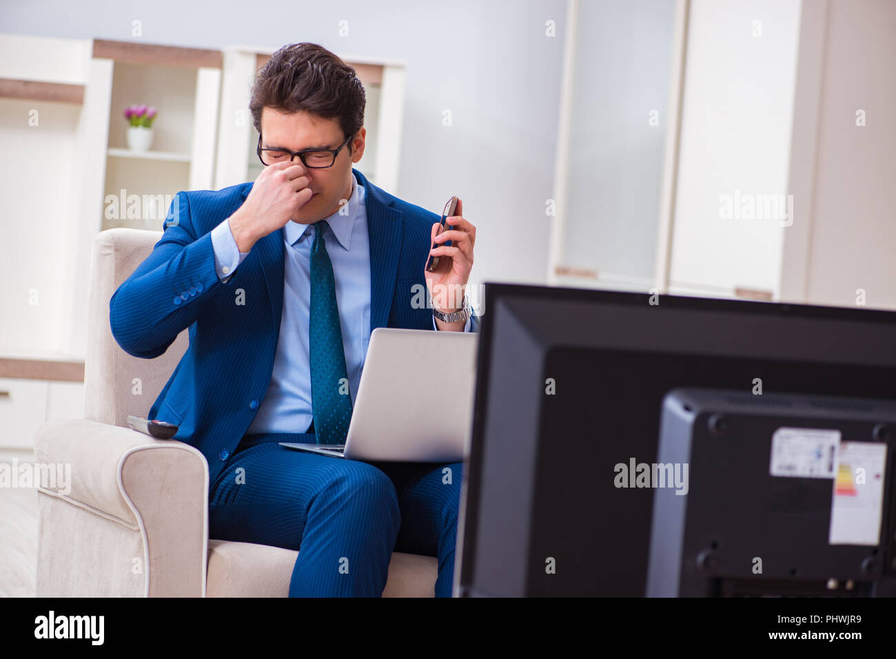 Businesman watching tv in office Stock Photo