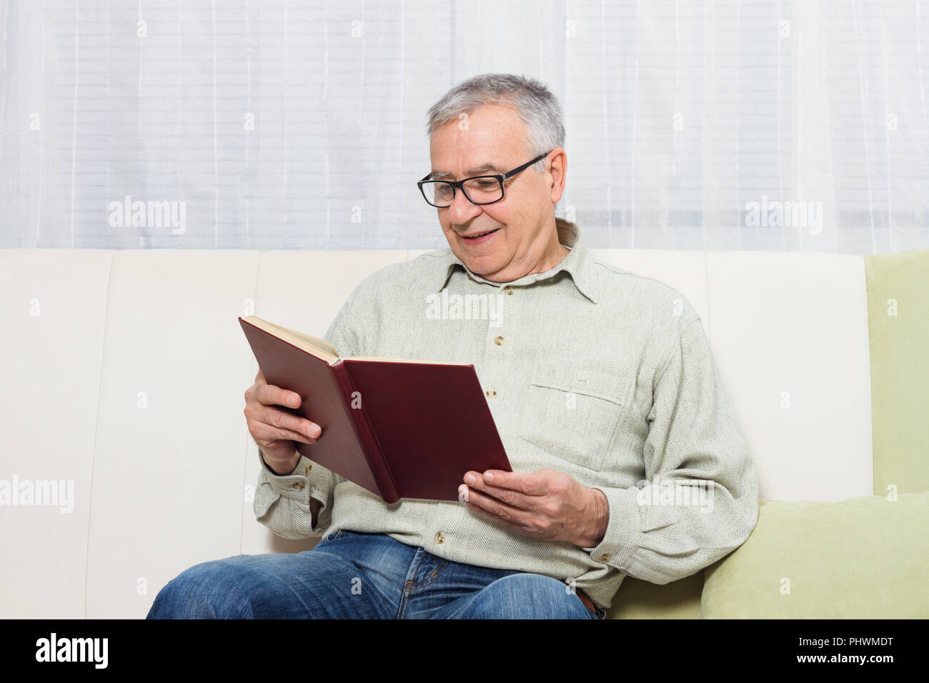 Candid senior man reading hi-res stock photography and images - Alamy