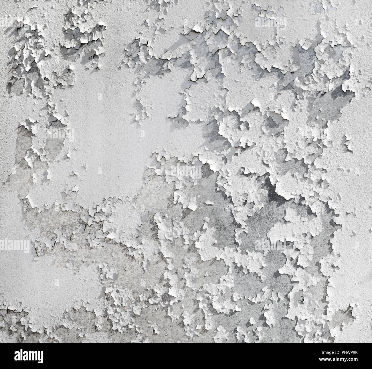 Old cracked wall with white peeling paint texture. Grunge background. Stock Photo