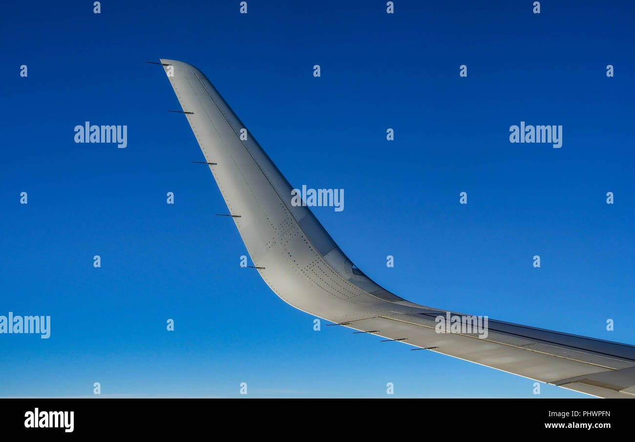 Curved wingtip, known as a “winglet”, of a modern passenger jet. The winglet design improve an aircraft’s fuel efficiency. Stock Photo