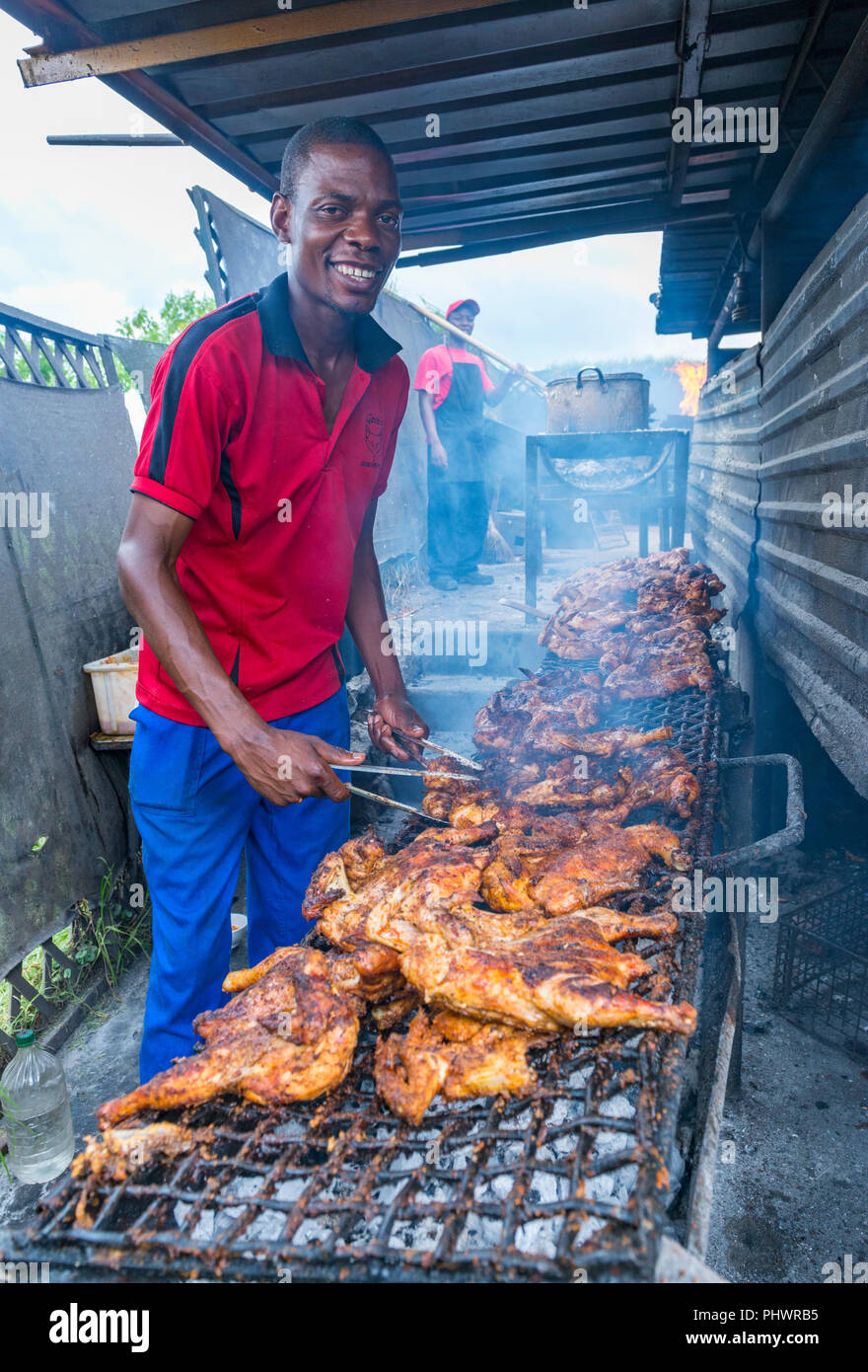 A local Zimbabwean prepares food in a traditional restaurant in Harare. Stock Photo