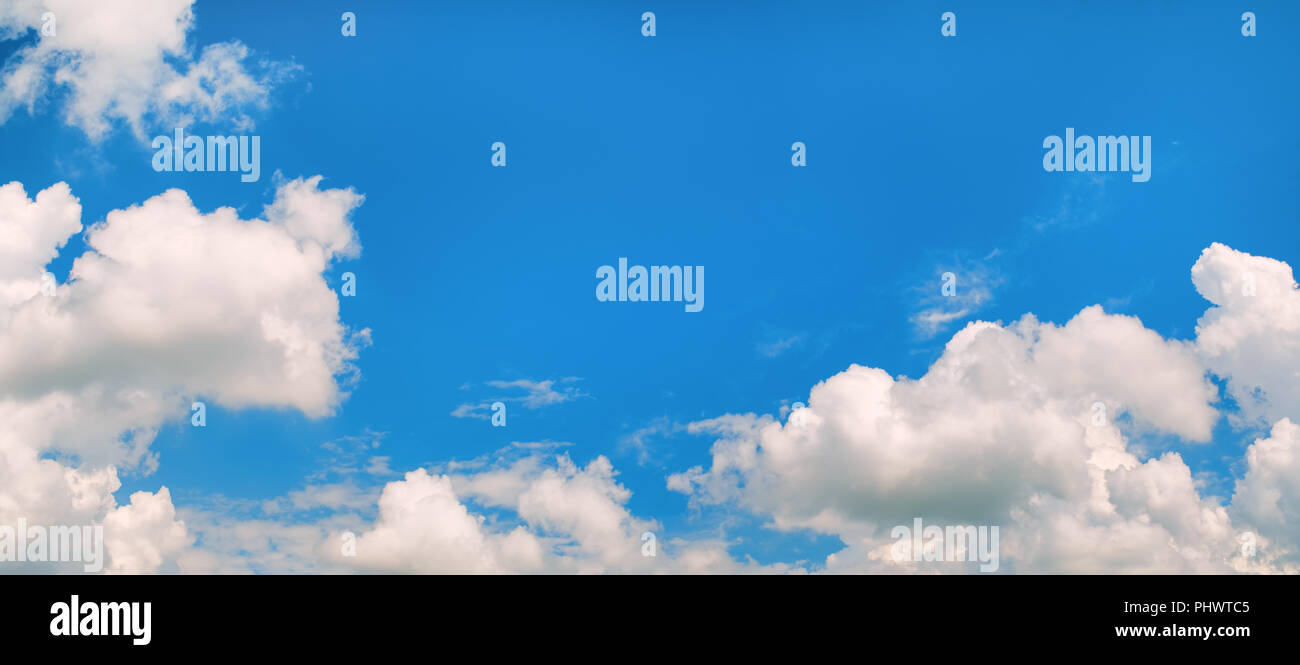 Blue sky background with cumulus clouds. Panoramic shot Stock Photo - Alamy