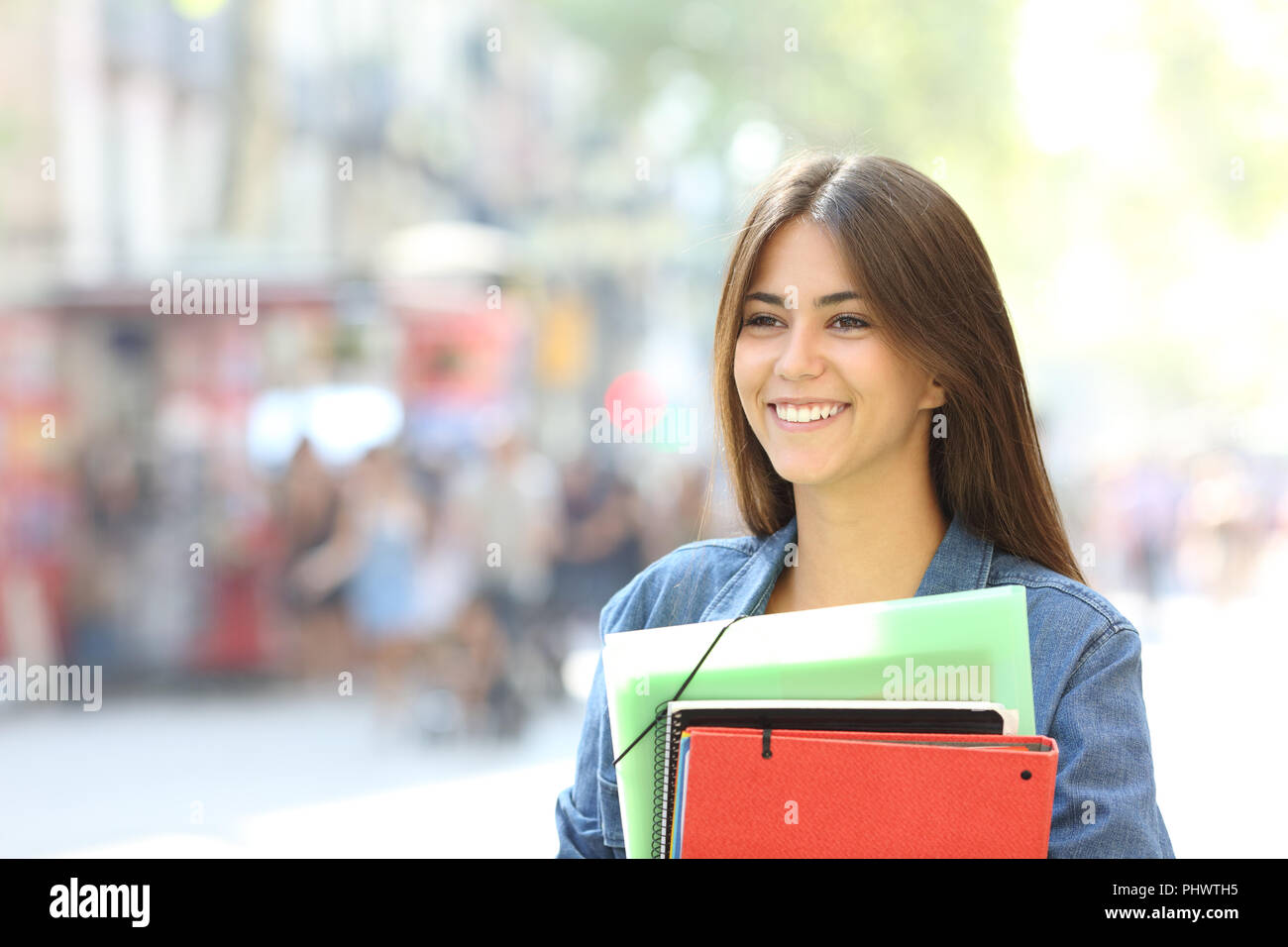 Holding student walking looking away smiling hi-res stock photography ...
