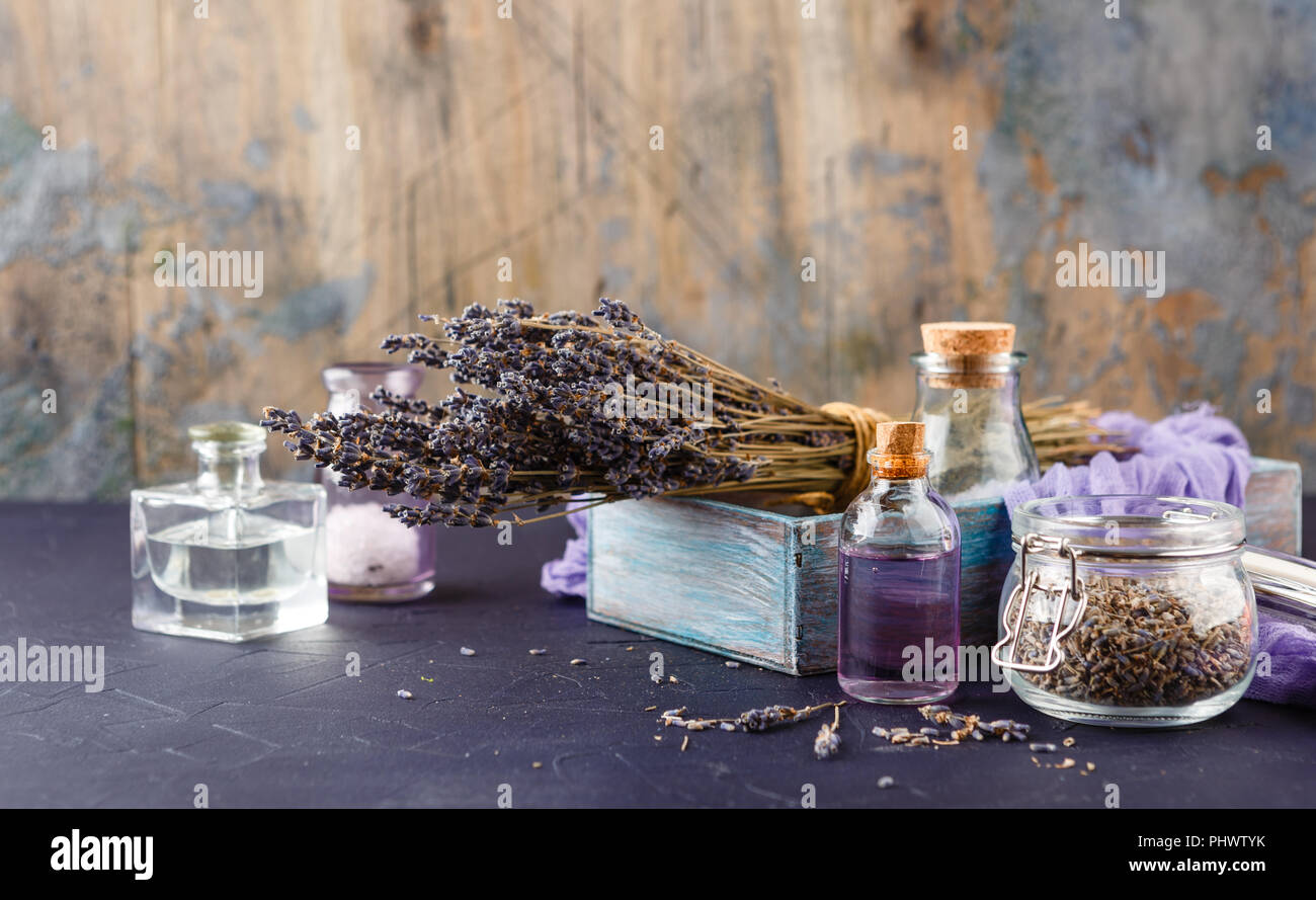 Essential lavender oil and dry lavender flowers. Stock Photo
