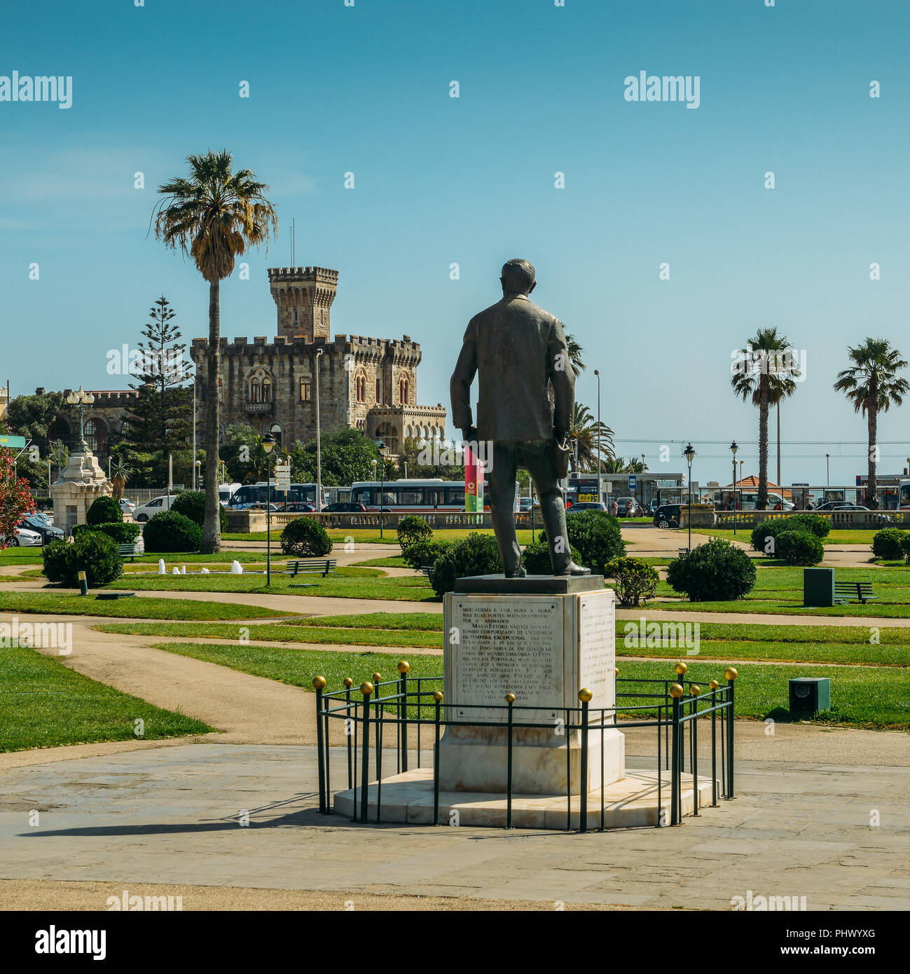 Estoril, Portugal - August 30, 2018: Statue of Fausto Cardoso and Baronial Estoril Castle in background overlooking the ocean Stock Photo