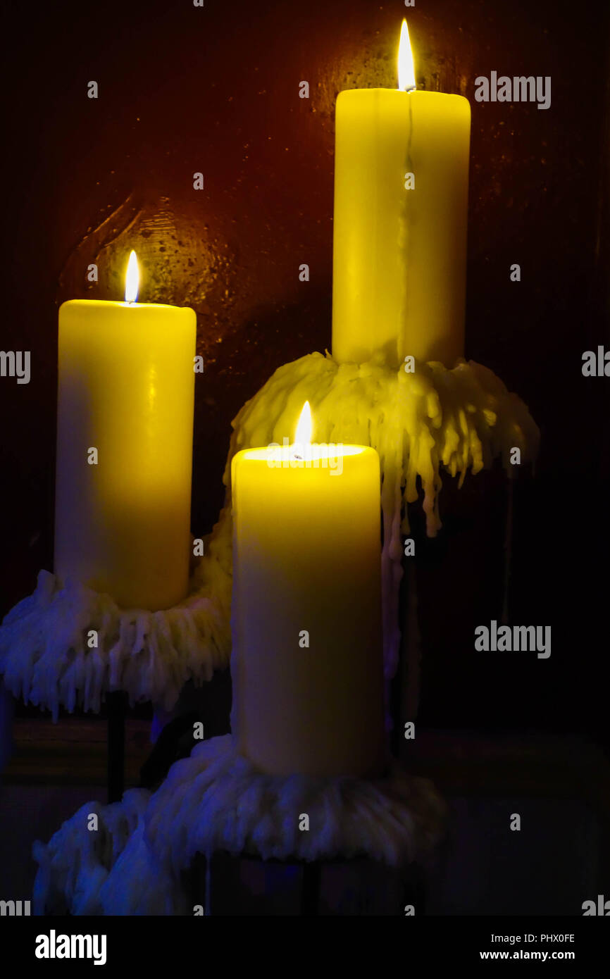 Tree burning candles with wax dripping. Stock Photo