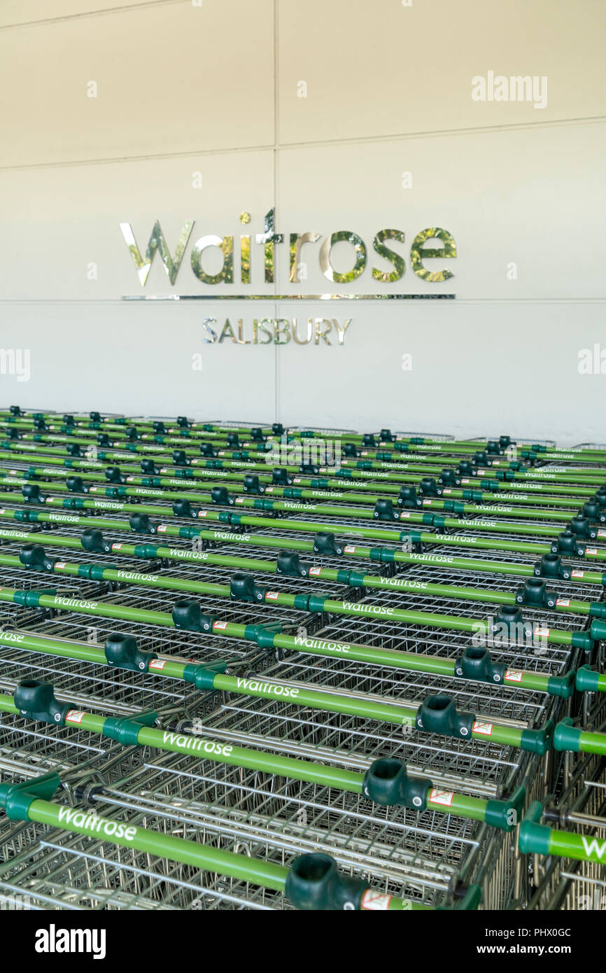 Rows of Waitrose supermarket shopping trolleys Stock Photo