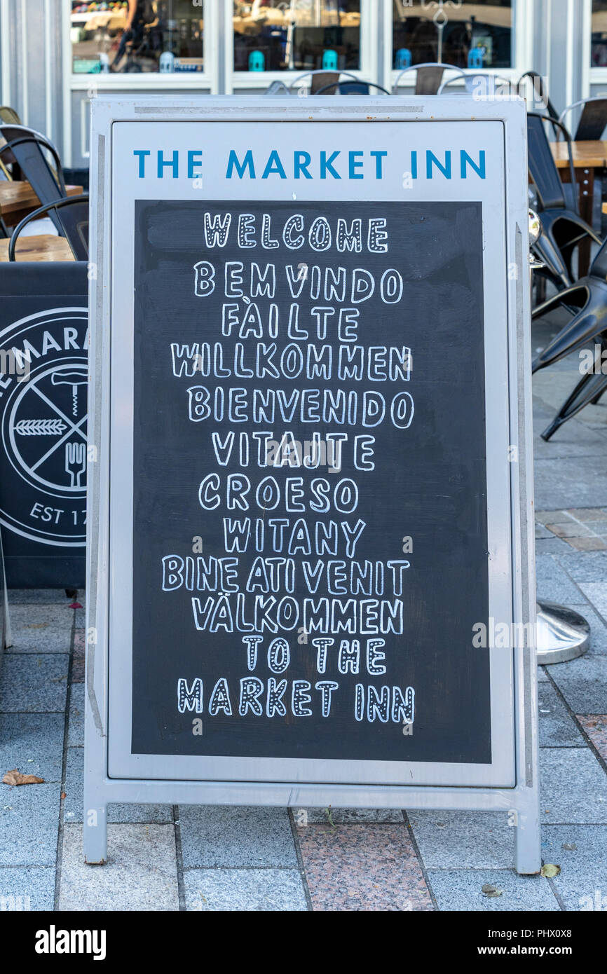 Pub chalk board displaying the word welcome in a number of different languages Stock Photo