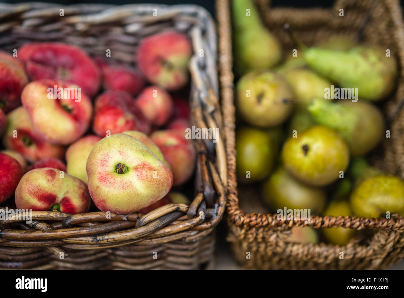 Nectarines and pears in wicker basket Stock Photo