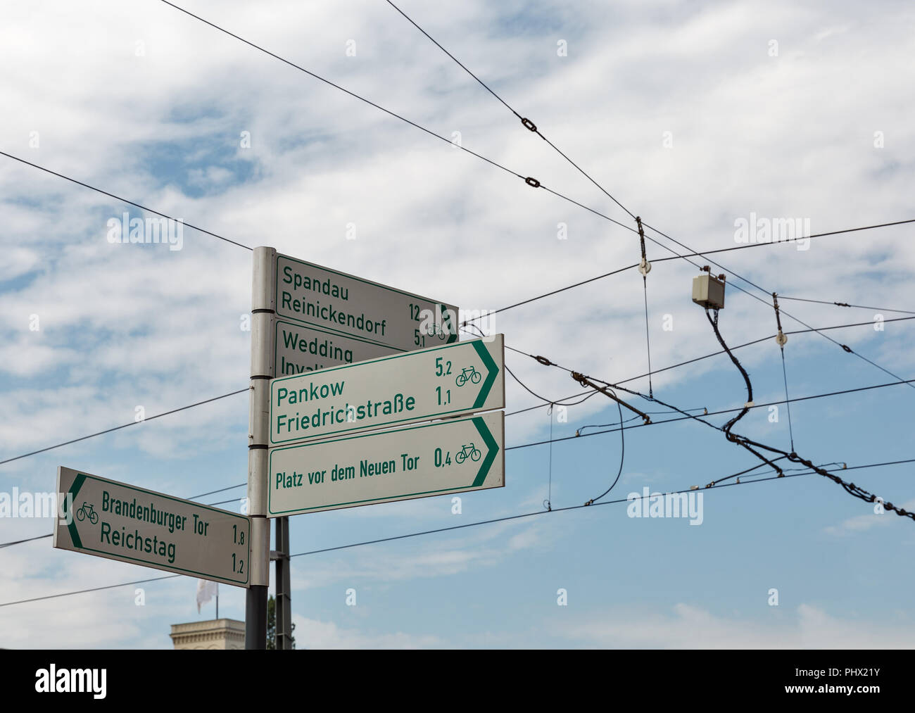 Street signpost against cloudy sky in Berlin, Germany. Stock Photo