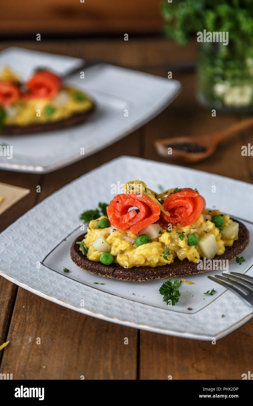 Smorrebrod with salmon and scramble egg on rye bread Stock Photo - Alamy