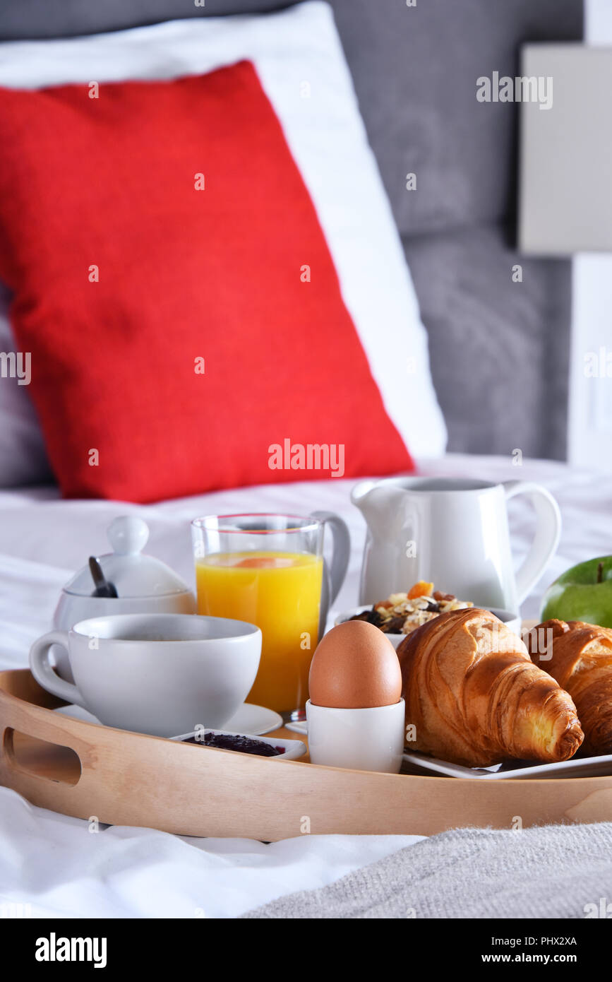 Breakfast on tray in bed in hotel room Stock Photo Alamy