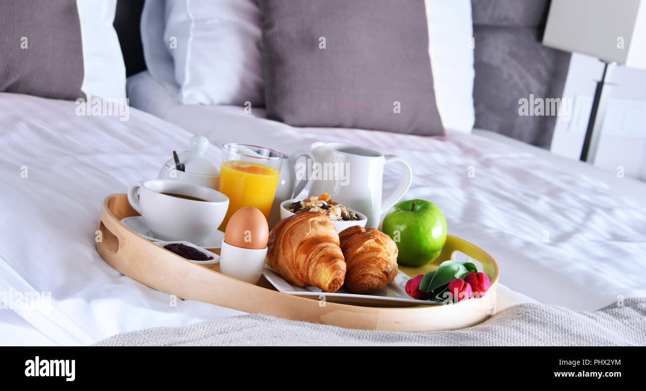 Breakfast on tray in bed in hotel room Stock Photo - Alamy