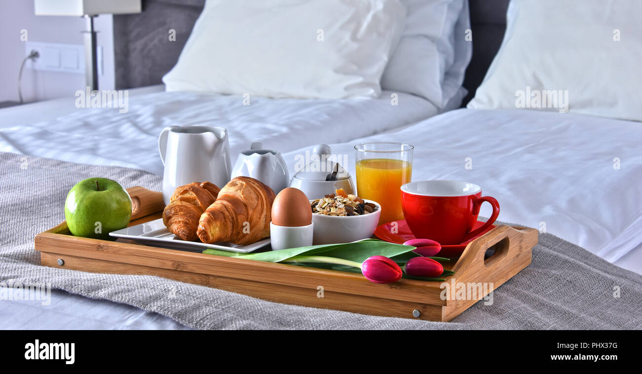 Breakfast on tray in bed in hotel room Stock Photo - Alamy