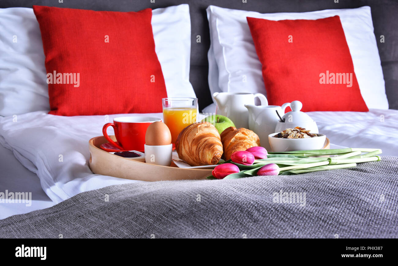 Breakfast on tray in bed in hotel room Stock Photo - Alamy