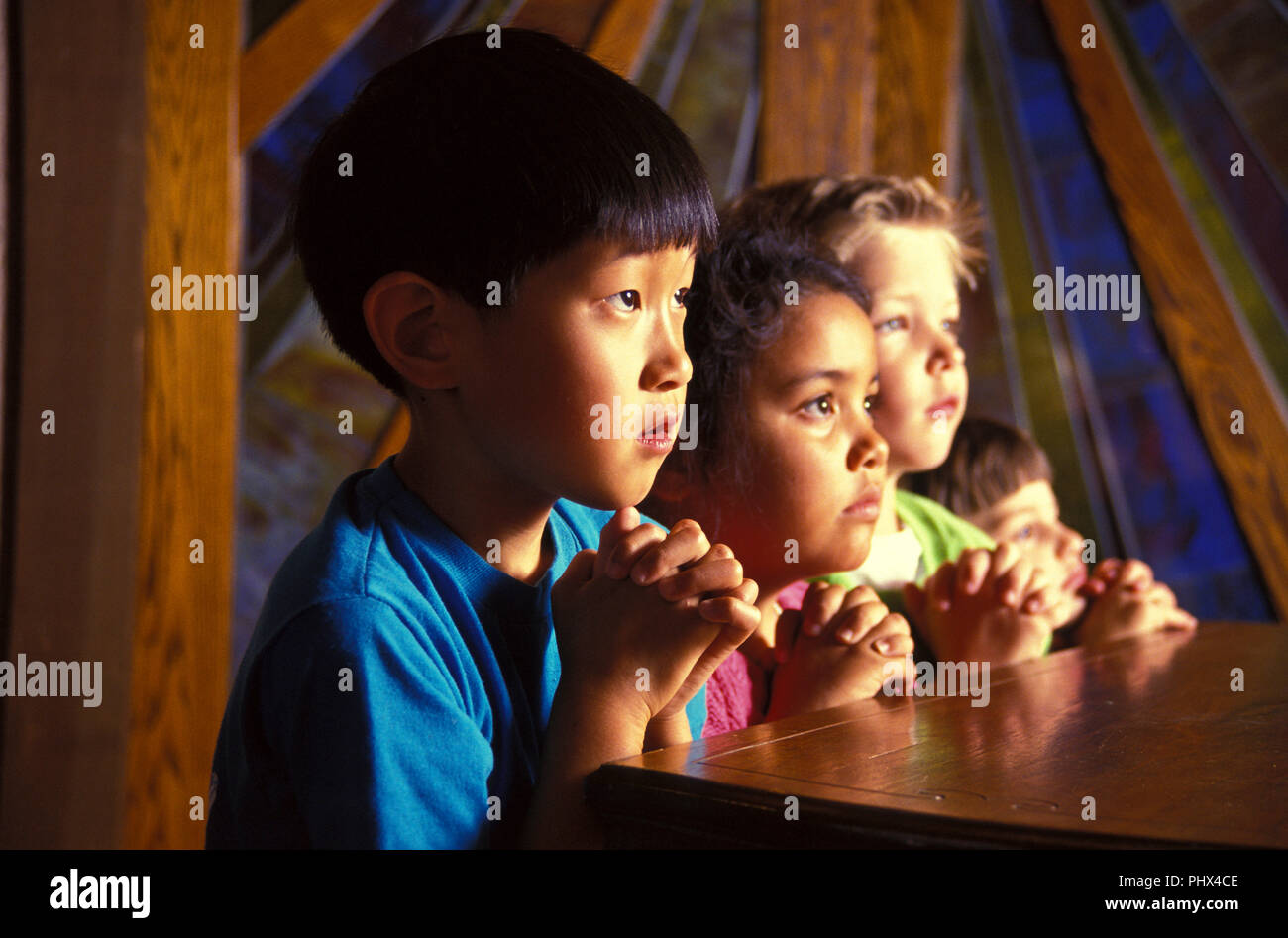 Ethnically mixed group of young Christian children pray in church  MR  © Myrleen Pearson  ...Ferguson Cate Stock Photo