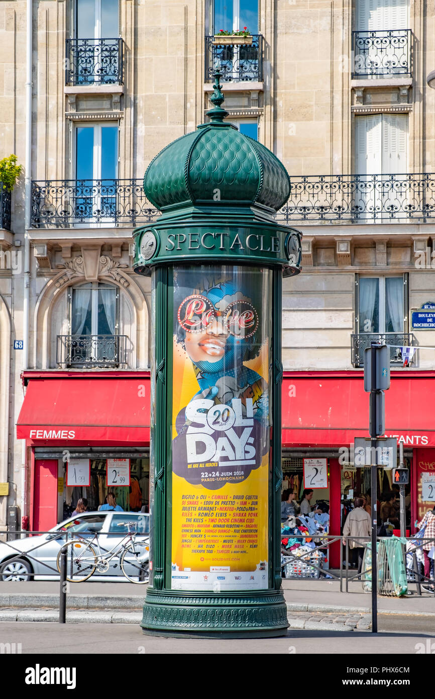 Revolving advertising sign located on a busy street in Paris. Stock Photo