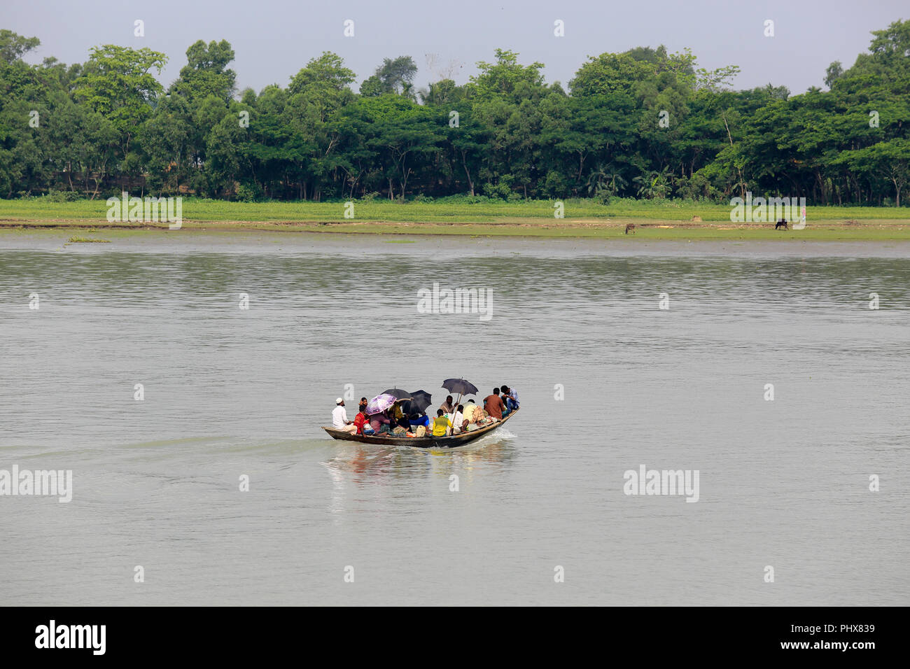 Rural people travel on a small boat through Tetulia River, Patuakhali ...