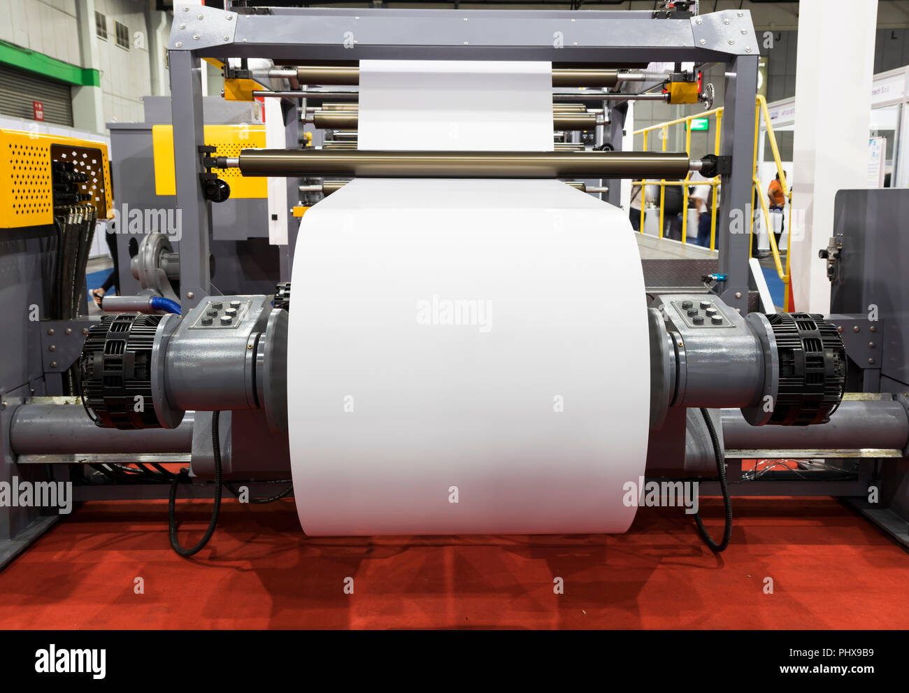 roll of white paper in modern paper cutting machine Stock Photo Alamy