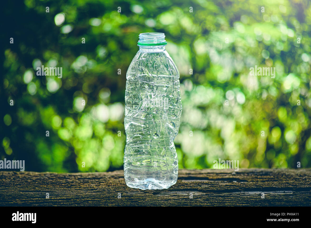crushing used a plastic bottle on old wood table Stock Photo
