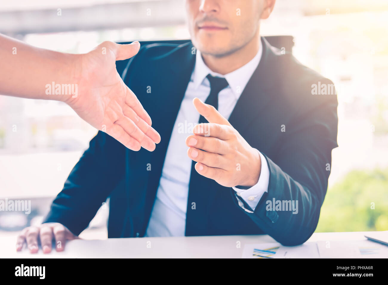 Business man giving his hand for handshake to partner , partnership teamwork or successful deal concept Stock Photo