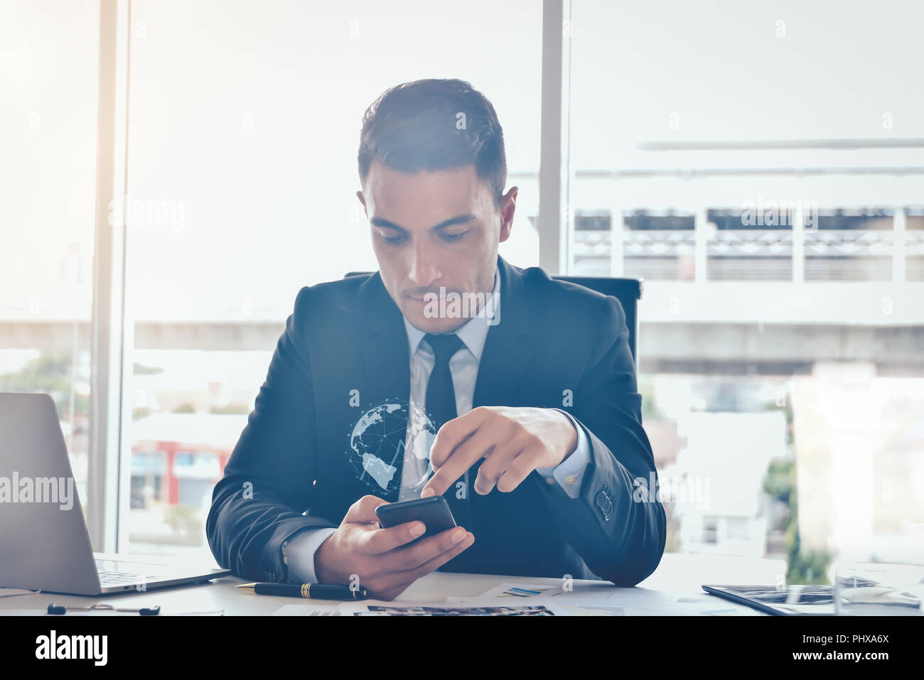 Internet of things concept,Businessman using smartphone with technologies monitor stock market business and technology concept Stock Photo