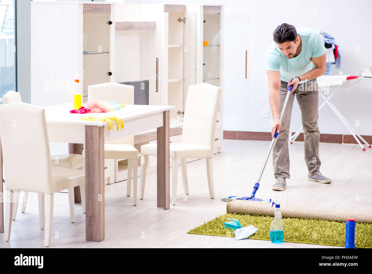 Young attractive man husband doing mopping at home Stock Photo Alamy