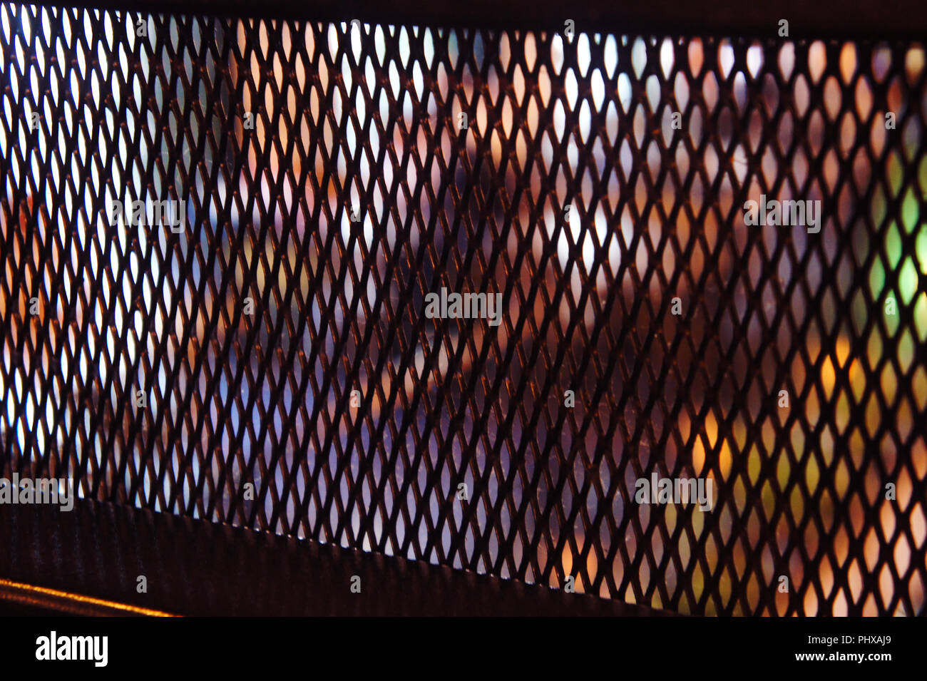 iron decorative mesh in the cafe. loft dyeing, city lights Stock Photo