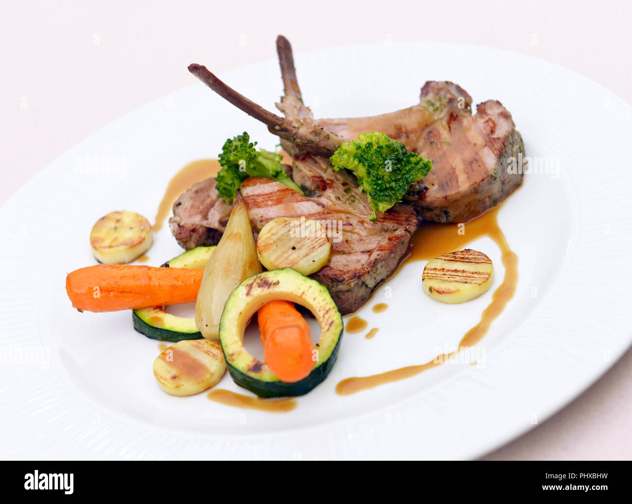 rack of lamb with vegetables on a plate Stock Photo