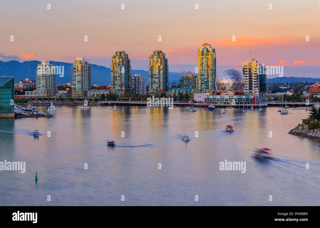 Vancouver skyline over False Creek at sunset with condominium towers and the geodesic dome of Science World, British Columbia, Canada Stock Photo