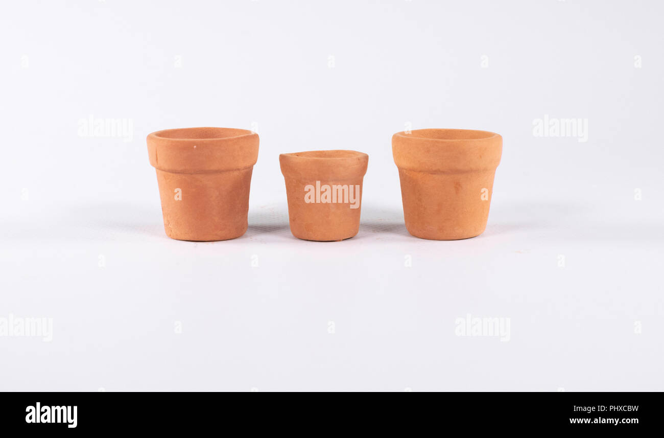 Set of three empty terracotta pots isolated on white Stock Photo - Alamy