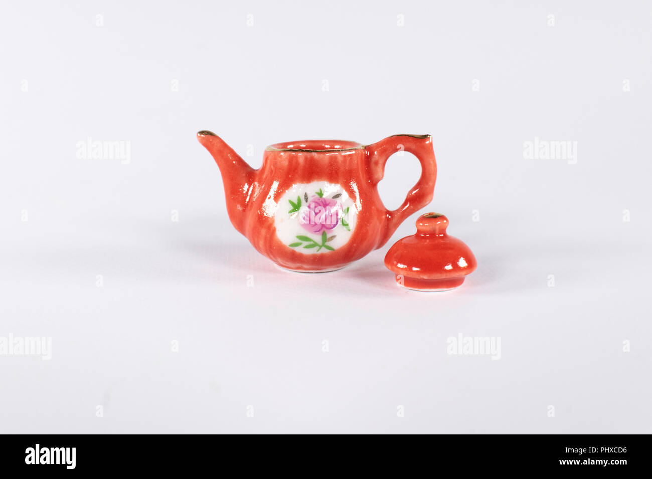 Handmade vintage style teapot with a flower design. isolated Stock